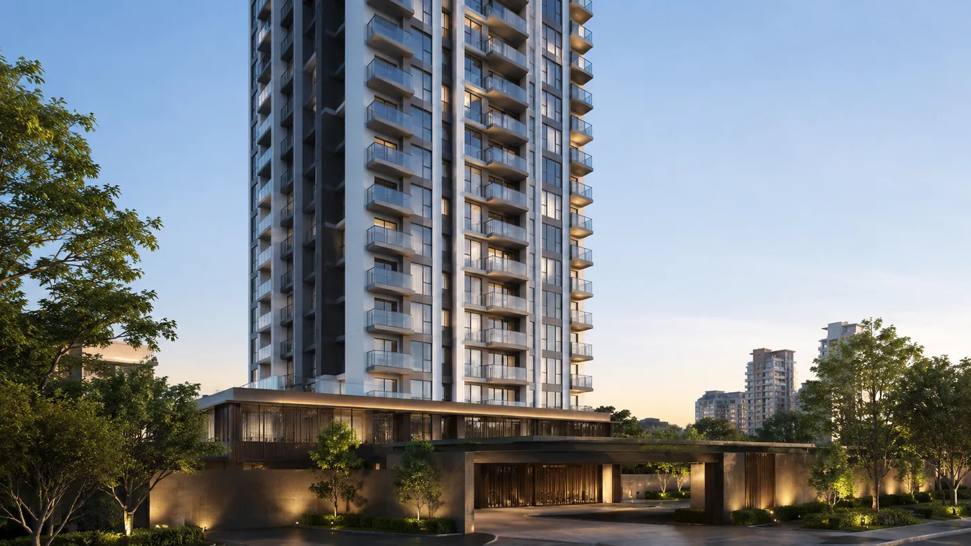 New residential tower at dusk with a lit landscaped entrance